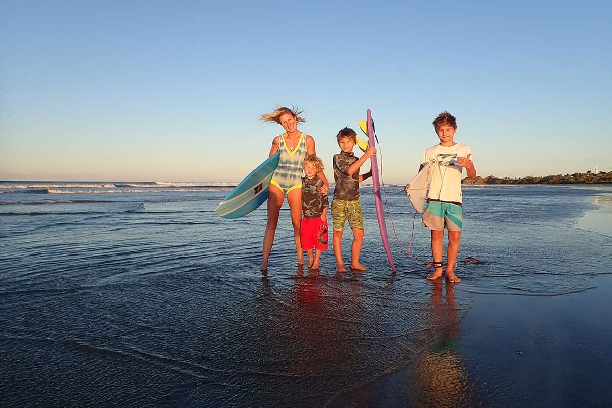 family jumping on surfing holiday